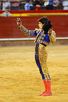 Matador with ear of bull, a 'trofeo' or trophy for a good performance, Plaza de Toros, Valencia, Spain. July 2014.