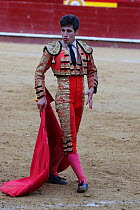 Bull fighter / torero in traditional costume with cape, Plaza de Toros, Valencia, Spain. July 2014.