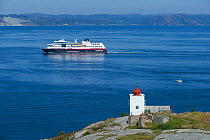 Agdenes lighthouse and cruise ship, Trondheimsfjord, Norway, July.