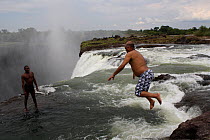 Photographer Steve O Taylor jumping into the Victoria Falls, Zambia November 2010.