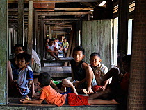 Dayak children in traditional longhouse, Pontianka, West Kalimantan, Indonesian Borneo. June 2010.