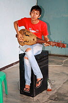 Local musician practicing. Singkawang,  West Kalimantan, Indonesia Borneo. June 2010.
