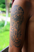 Dayak man with non traditional tattoo, Central Kalimantan,  Indonesian Borneo. June 2010.