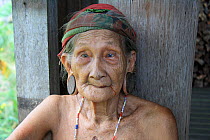 Elderly Dayak woman with ear lobes stretched, Central Kalimantan, Indonesian, Borneo. June 2010.