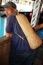 Dayak people, man with basket bag, evicted from home for dam construction, Sabah, Malaysian Borneo. July 2010.
