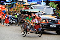 Bicycle rickshaw, Singkawang city. West Kalimantan, Indonesian Borneo. July 2010.