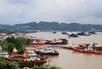 Port of Balipapan with barges full of coal from the open cast mines, East Kalimantan.  June 2010.
