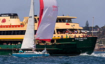 Sailboat passing a ferry in Sydney Harbour, New South Wales, Australia, October 2012. All non-editorial uses must be cleared individually.