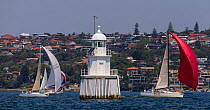 Sail boats racing around a lighthouse in the Sydney Harbour, New South Wales, Australia, October 2012. All non-editorial uses must be cleared individually.