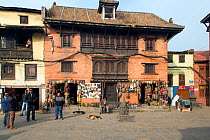 Historic buildings and shops selling masks, at the Monkey Temple or Swayambhunath, Kathmandu, Nepal. November 2014.