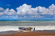 Small crab boat coming in to Weybourne beach, Norfolk, England, UK. August 2014.