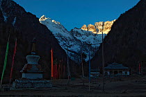 Stupa and temple in the shadow of Kawakarpo Mountain, Meri Snow Mountain National Park, Yunnan Province, China. January 2010.
