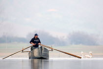 Fisherman rowing boat on Lake Kerkini. Lake Kerkini, Greece. February