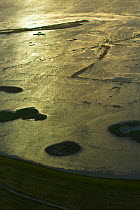 Aerial view of Steart Marshes Wildfowl and Wetland Trust, agricultural land transformed into wetland reserve, at sunrise, Somerset, UK, February 2015.  This area has been allowed to flood by the WWT a...