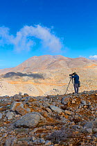 Birdwatcher looking through telescope, Mount Hermon, Israel, November 2014.