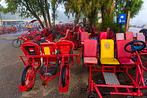 Rickshaws, bike cars and four wheel bicycles available for tourists to rent, Hula Valley, Israel, November.