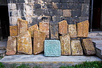 Cross-stones (khachkars) placed along church wall, Armenia, May.