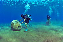 Divers are setting up concrete reef balls to build an artificial reef, Philippines, Sulu Sea. August 2014.