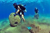 Divers are setting up concrete reef balls to build an artificial reef, Philippines, Sulu Sea. August 2014.