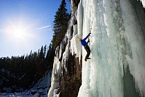 Ice climber on ice cliff, Hallingdal, Norway, March 2005.