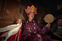Naxi shaman performing ceremony, Yunnan, China, July 2010.