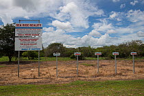 Signs about sea level rise, along floodplains of Arnhem Highway, Northern Territory, Australia.