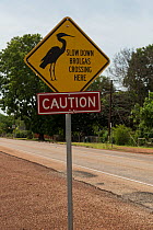 Caution sign which reads :  Slow down Brolgas crossing here, Northern Territory, Australia.