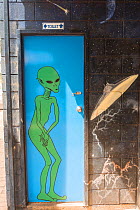 Toilet door with alien mural at Wycliffe Well UFO capital of Australia along the Stuart Highway,Northern Territory, Australia.