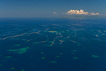 Aerial view of scattered small reefs with coral spawn on the water's surface.  Western Division, Fiji. December 2013.