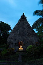 Village Chief Ratu Jovilisi Nagatalevu inside hisl Fijian bure hut,traditionally made with forest wood and straw roof and walls, Mali Island, Macuata Province, Fiji, South Pacific.