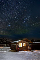 Cabin in snow on starry night, Buffalo Ranch, Lamar Valley, Yellowstone National Park, Wyoming, USA. February 2015.