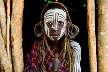 Girl with traditional clothes and ornaments. Mursi Tribe, Mago National Park. Ethiopia, November 2014