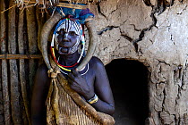 Married woman with traditional clothes and ornaments, with her lip plate removed, Mursi Tribe, Mago National Park. Ethiopia, November 2014