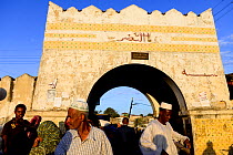 Busy street scene with archway in Harar, an important holy city in the Islamic faith, UNESCO World Heritage Site. Ethiopia, November 2014