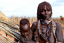 Hamer woman with her son, in traditional clothes and ornaments. Territory of the hamer tribe. Lower Omo Valley. Ethiopia, November 2014