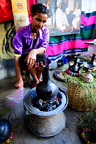 Woman preparing traditional Ethiopian coffee. Lalibela. Ethiopia, December 2014.