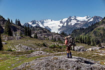 Hiker in Ferry Basin, Bailey Range Traverse, Olympic National Park, Washington, USA, August 2014. Model released.