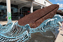 The Bristol Whales - wicker sculpture of two Blue whales surfacing surrounded by plastic bottles. Art installation by Cod Steaks to mark the Bristol Green Capital 2015. Millennium square, Bristol, Eng...