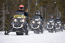 Snowmobilers in Yellowstone National Park, USA, February 2013.