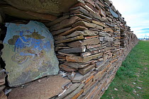 Tibetan art work in wall on Mani prayer stones, Serxu, Shiqu county, Sichuan Province, Qinghai-Tibet Plateau, China. August 2010.