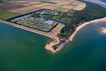 Aerial view of lifeboat station, beach huts and caravan park at Wells-Next-The-Sea, Norfolk, England, UK, September 2009.