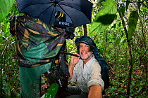 German wildlife photographer Konrad Wothe at work in the peruvian rainforest, Panguana reserve, Amazonian Basin, Peru. October 2013.