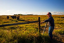 Lynn Ballagh closing gate on his cattle ranch, Sandhills of Nebraska, Garfield County, Nebraska, USA.