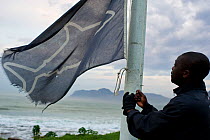 Dennis Chikodze hoists the black flag at the Kalk Bay post. It provides a warning to ocean goers that visibility is bad and the shark spotters may not see a white shark if it does enter the bay.  West...