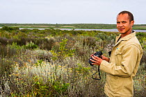 Man birdwatching  in Rocherpan National Park, Western Cape, South Africa.