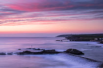 View overlooking Bude breakwater/ harbour at sunset, Bude, Cornwall, UK. April 2015.