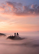Corfe Castle at dawn with mist, Corfe Castle, Dorset, UK. September 2014.