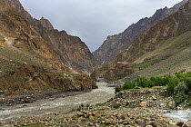 Pyandzh River Gorge along the border between Tajikistan (right) - Afghanistan (left) Badakhshan Region, Pamir Mountains, Central Asia. June.