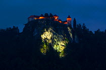 Bled Castle on cliff top at night, lit up , Bled, Slovenia, October 2014.