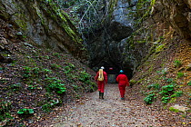 People entering Cross Cave (Krizna Jama), Cross Mountain, Green Karst, Slovenia, October 2014.